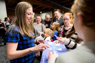 Chelsea Clinton, daughter of democratic candidate Hilary Clinton, signs an campaign poster for supporters while campaigning for her mother at Fuse Coworking in the Haymarket. KRISTIN STREFF/Journal Star